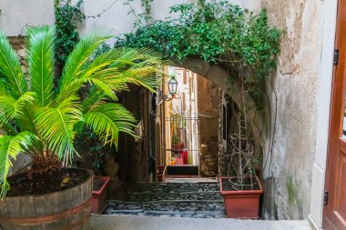 Italy, Sicily, Messina Province, Francavilla di Sicilia. Arched cobblestone desending walkway of town. clipart