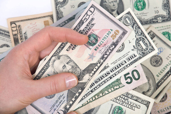 Human hand counting us dollar bills