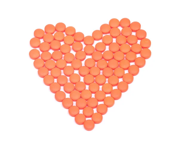 心臓形状オレンジ色の錠剤 — ストック写真