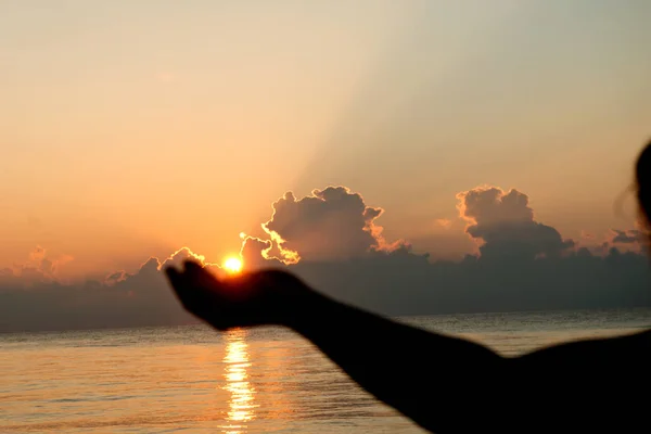 Sziluettjét emberi nyitott üres kézzel a tenyér felfelé át a nap — Stock Fotó
