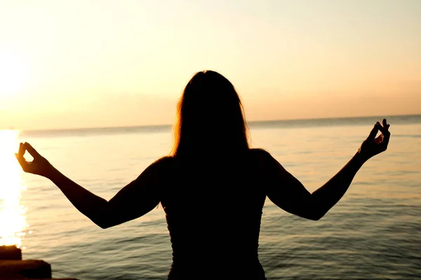 Silhouette human open empty hands with palms up over sun — Stock Photo, Image