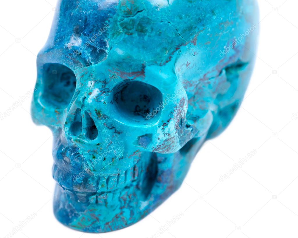 Gemstone chrysocolla carved realistic crystal skull from Peru isolated on white background
