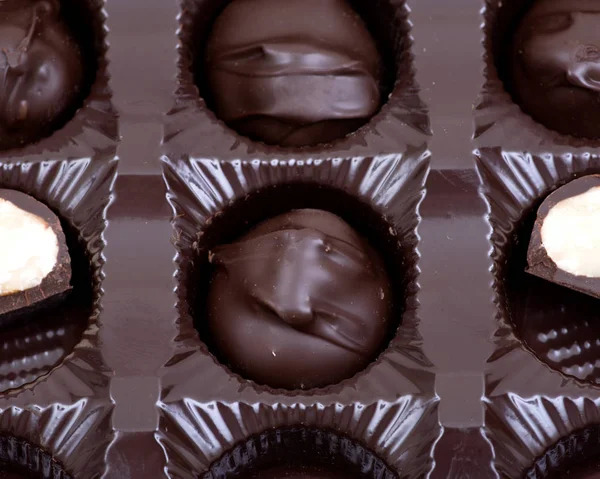 Dark chocolate covered macadamia nuts in plastic packaging