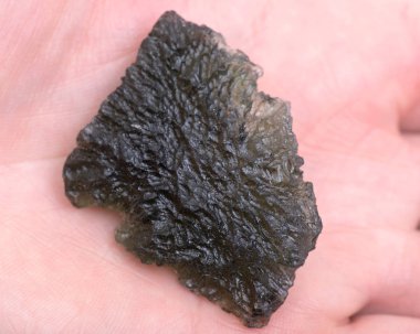 Moldavite - form of tektite found along the banks of the river Moldau in Czech republic clipart
