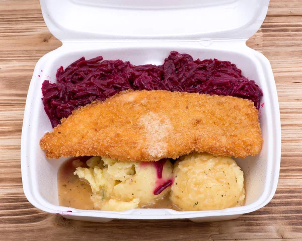 Breaded chicken breast with mashed potatoes and stewed beets in biodegradable takeout box