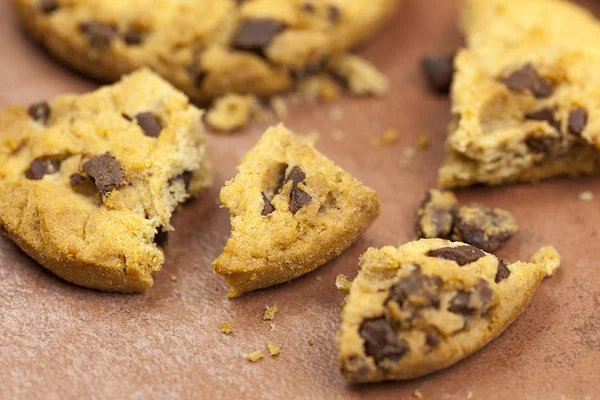 Broken chocolate chip cookies on a tiled worktop — Stock Photo, Image