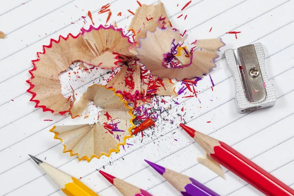 Colouring pencil shavings on a lined note pad — Stock Photo, Image