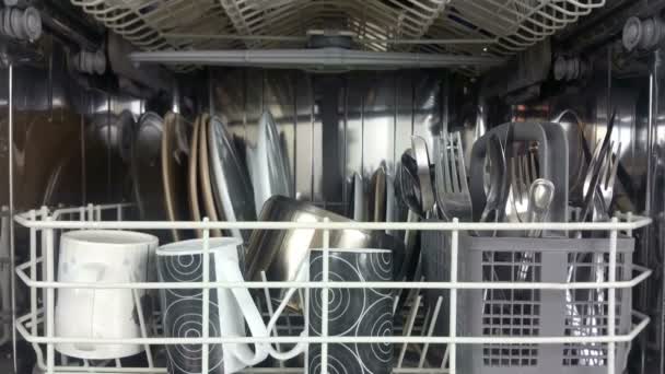 Elevating shot of a dish washer loaded with crockery and cutlery — Stock Video