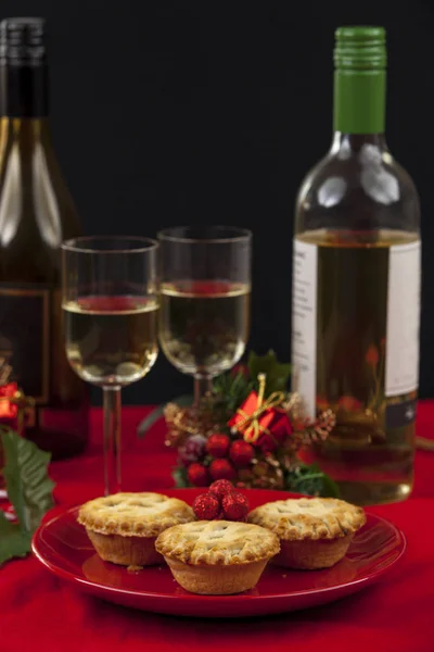 Pasteles de carne picada con copas y botellas de vino en una mesa en Cristo — Foto de Stock