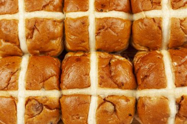 Above close up of a batch of hot cross buns