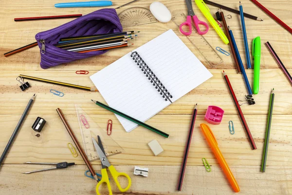 Blank note book pages on a messy wooden school desk — Stock Photo, Image