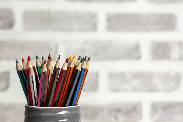 Colouring pencils stored in a grey clay jar — Stock Photo, Image