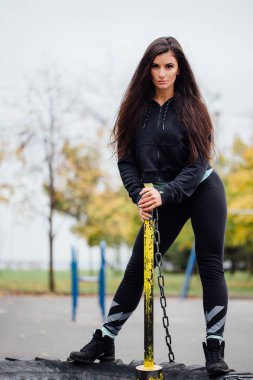 Park çekiç ve Traktör Lastiği ile poz kız.