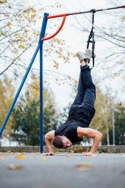 Trx eğitim. Adam eğitmen parkta Excersise yapıyor. Fitness Egzersiz.