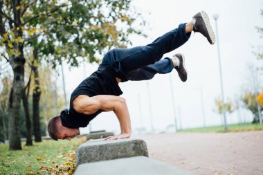 Egzersiz, sonbahar parkta egzersiz yaparak erkek atlet. Push up ile tezgah.