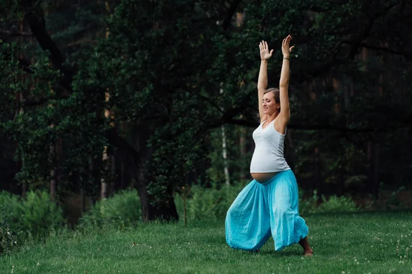 Hamile yoga doğum öncesi analık farklı egzersizleri yapıyor. parkta çim, nefes, germe, statik. — Stok fotoğraf