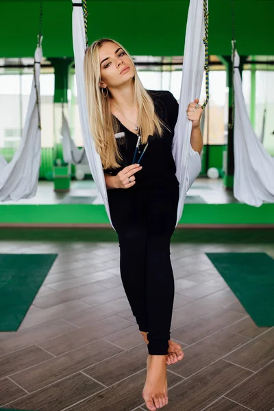 Portrait of a cute beautiful girl mekeup artist natural with long hair blond. In the studio, anti gravity fitness yoga . — Stock Photo, Image