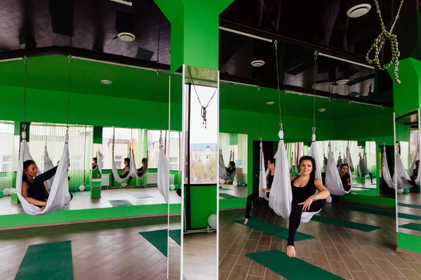 Anti yerçekimi yoga egzersizleri ile bir grup insan yapma genç kadınlar. Aero sinek fitness eğitmeni egzersiz. Beyaz hamak.