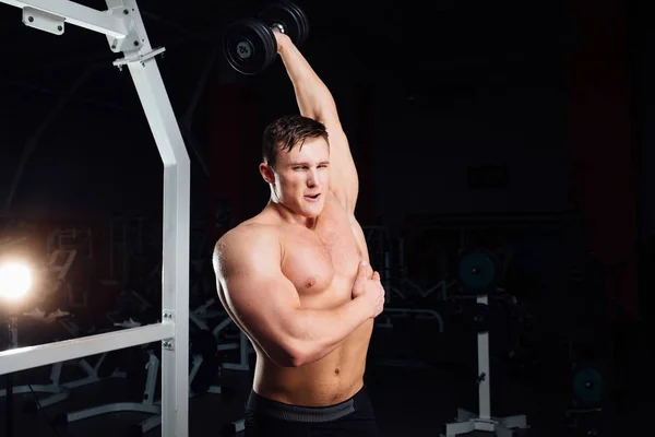 Närbild porträtt av professionell bodybuilder stark muskulös yang man gör övning. Träning med skivstång på gymmet. Sport och fitness. Utbildning kille pumpar upp händerna triceps. — Stockfoto