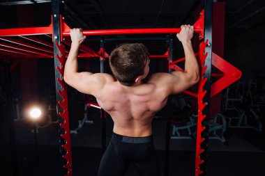Pull ups yakışıklı sporcu spor salonunda yapan güçlü erkek. büyük emin kas eğitim.