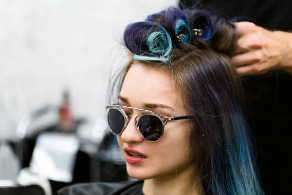 Headshot de uma jovem mulher com encrespadores de cabelo em um salão de beleza . — Fotografia de Stock