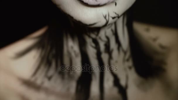 Fashion close-up portrait of model female with a amazing creative make-up. Painted muah silhouettes. — Stock Video