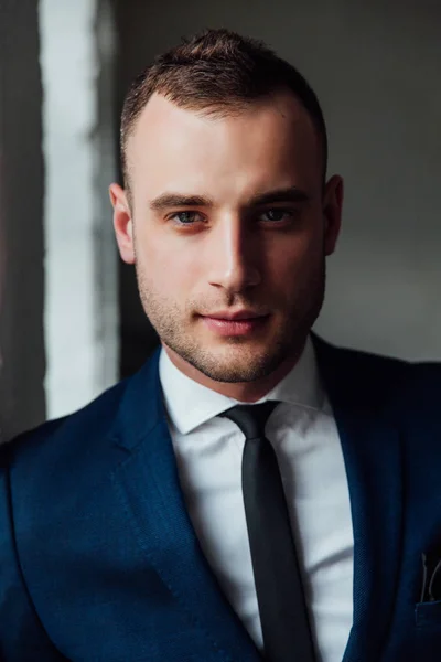Młody biznesmen atrakcyjny i pewny siebie w Niebieski garnitur i krawat czarny. — Zdjęcie stockowe