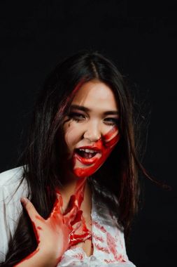 bir genç, güzel Asyalı kız Halloween yakın çekim portresi. kadın onu kapsayan kanlı el yüz.