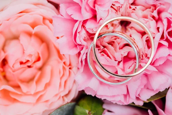 Anéis de casamento fechar macro no botão peônia rosa . — Fotografia de Stock