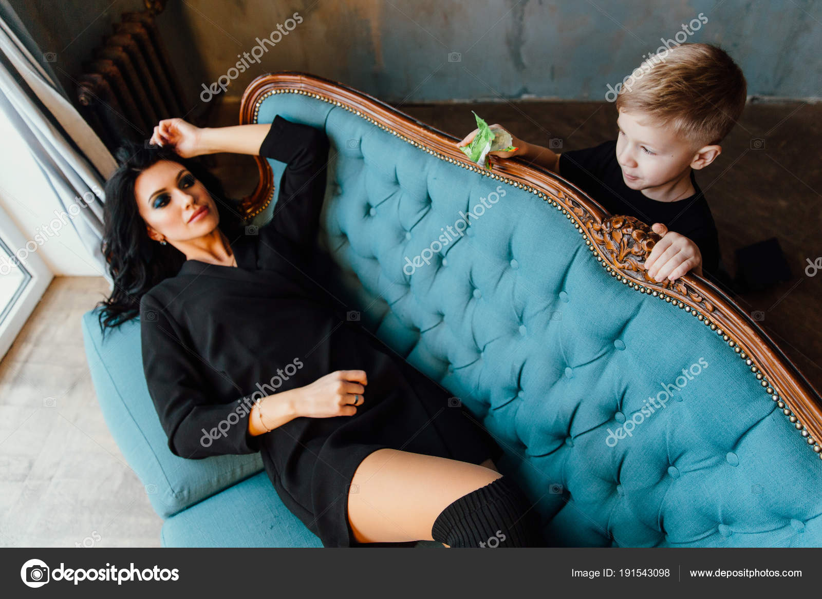 Beautiful Brunette Mom Hugging Her Son Lying On The Sofa Family Mother And Her Cute Boy Black Clothes Stock Image Beautiful Brunette Mom Hugging Her Son Lying On The Sofa Family Mother And Her Cute Boy Black Clothes Stock Image