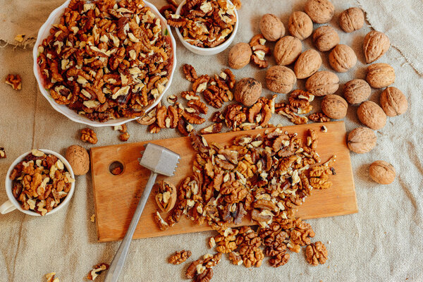Assortment of nuts. Bowl of walnuts on wooden texture. Walnuts a
