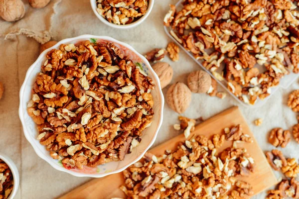 Assortment of nuts. Bowl of walnuts on wooden texture. Walnuts a