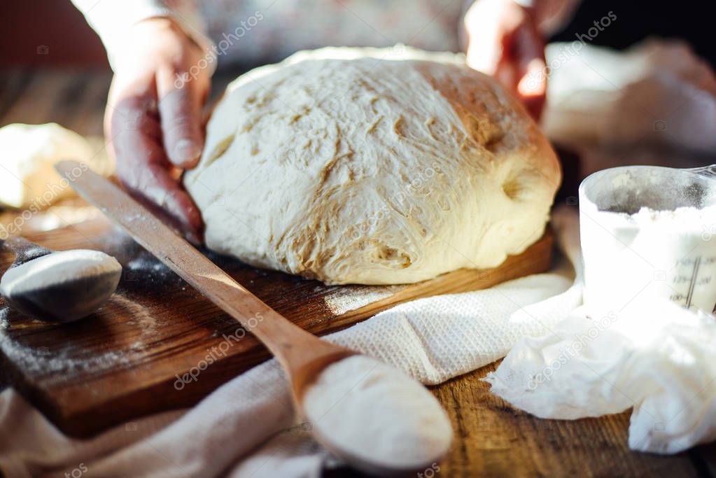 Close up view of baker kneading dough. Homemade bread. Hands pre