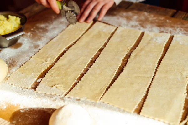 Making of pierogi with potato Vareniki. Russian food . Rustic