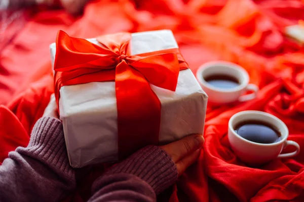 Sevgililer günü kavramı. Ahşap backgr üzerinde kırmızı fiyonklu hediye paketi — Stok fotoğraf