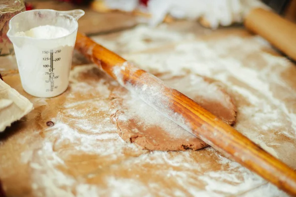 Руки режут печенье из сырого теста на деревянном столе. Здоровый пекарь — стоковое фото