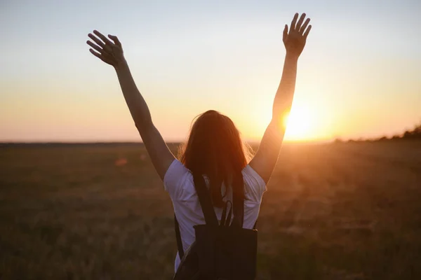 Portrait of happy and enjoying young woman on a meadow on a suns — Stock Photo, Image