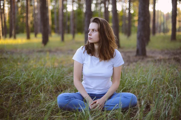 Frau praktiziert Yoga und meditiert in der Lotusposition auf der — Stockfoto