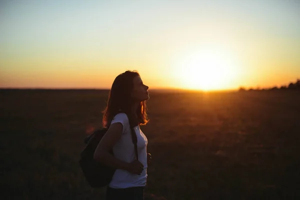 Portrait of happy and enjoying young woman on a meadow on a suns — Stock Photo, Image