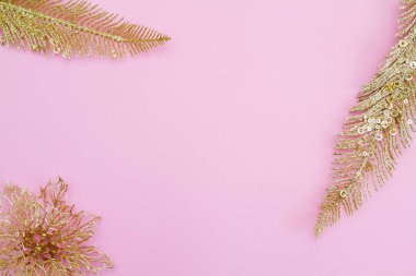 Parlak, parlak, altın renkli Noel tüyleri ve çiçekler kağıt üzerinde. Yeni yıl ve Noel konsepti. Mesaj için yer. Boş boşluk