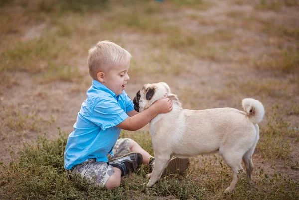The daily life of a child with disabilities. A boy with Down syndrome plays with dogs. Chromosomal and genetic disorder in the baby.