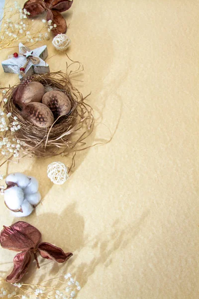 Easter composition religious concept. Chicken eggs in a nest with bird feathers. Cotton flower, Zero waste and lack of plastic.