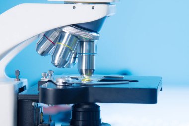 Biyoloji sınıfındaki sağlık görevlileri, öğrenciler ve akademisyenler için araştırma laboratuarı, histoloji veya histopatoloji eğitim sınıfında oküler ve bir bardak ışık veya floresan stereo mikroskop yakın çekim.