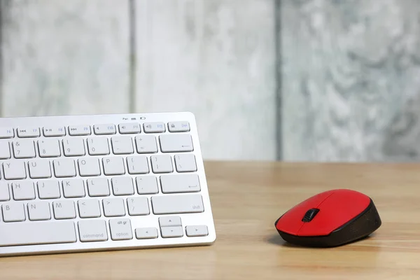 computer mouse and keyboard on a table. Retro alarm clock. Wooden background. Work place. Finance. Freelance