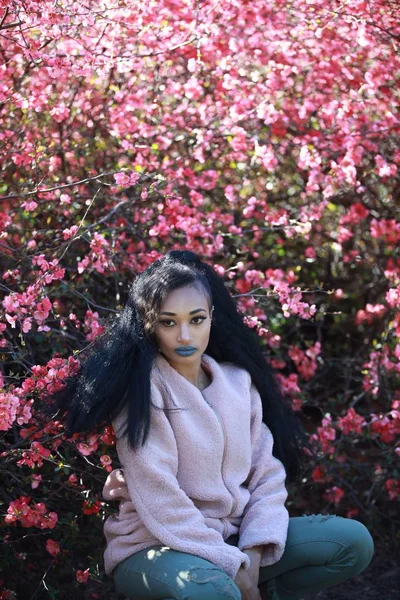 Stylish female posing near sakura tree — Stock Photo, Image