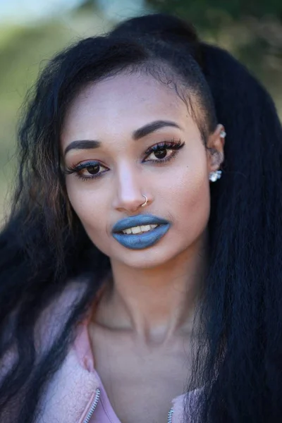 Brunette smiling female with blue lipstick — Stock Photo, Image