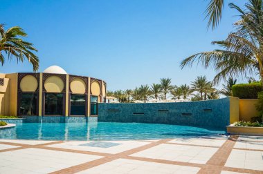 Dubai. In the summer of 2016. Oasis of the Hilton Ras Al Khaima hotel on the Persian Gulf. clipart