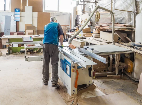 Worker sawing wood panel saw machine for furniture factory. Circular saw. Russia. Saint-Petersburg. June 2017 — 스톡 사진