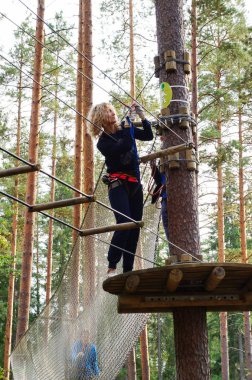 Etkinliği bir ip parkta mutlu genç kadının. Aşırı spor. 