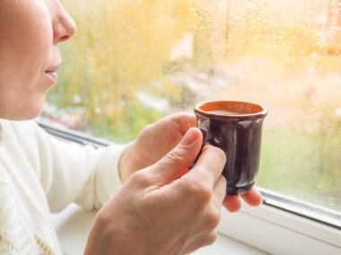 Pencere kenarında kahve içen adam..